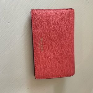 Salmon pink Kate Spade wallet.
